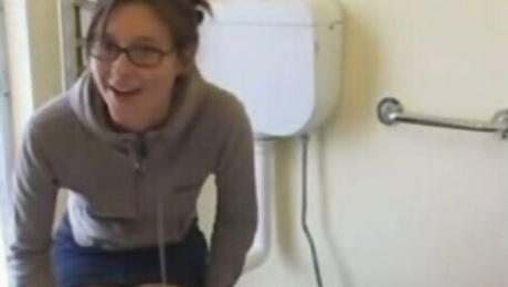 Nerdy college girl is in the public toilet after morning exercise
