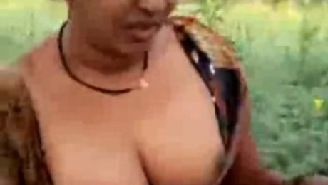 Mature dirty-minded Hindu brunette flashes boobs and cunt outdoors